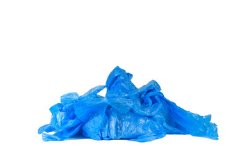 A pile of used blue shoe covers on a white background.