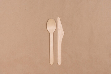 Wooden spoon and knife on craft paper