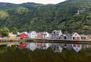 colored village reflected on water in Lærdalsøyri, Norway. Houses reflected on water