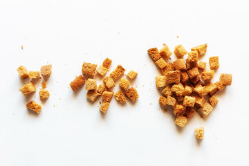 handfuls of white bread croutons on a light background close-up - obrazy, fototapety, plakaty