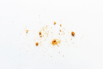 scattered crumbs of white bread rusks on a light background