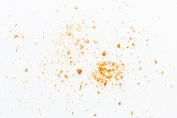 Fototapeta na wymiar scattered crumbs of roasted white bread on a white background closeup