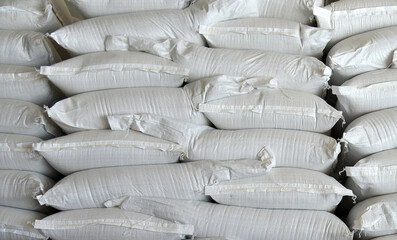 Obraz premium Bags of the ingredient are stacked on top of each other in an agricultural warehouse.