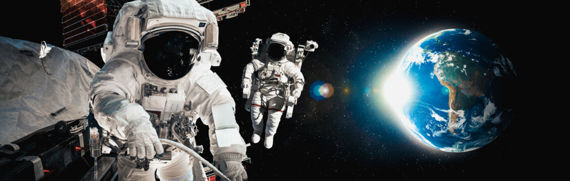 Astronaut spaceman do spacewalk while working for space station in outer space . Astronaut wear full spacesuit for space operation . Elements of this image furnished by NASA space astronaut photos. - Powered by Adobe