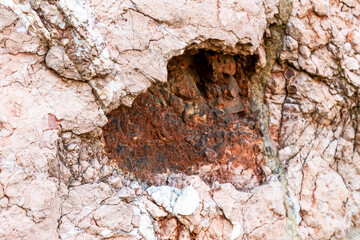 Damage from the fall of an artillery shell on the antique wall of an ancient building