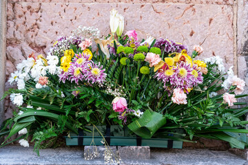 Bouquet of flowers on the old wall of the ancient church