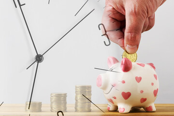 Clock on the background of a piggy bank. Financial savings concept. Savings. Business.