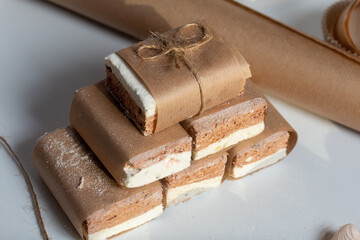 Portion marshmallow with cocoa and cranberries. Wrapped in paper and tied with string. Two-layer zephyr.