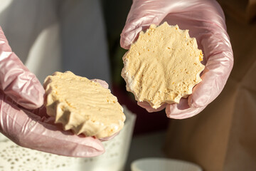 A woman is packing homemade marshmallows. Cooking marshmallows at home.