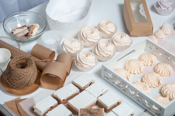 Homemade marshmallows of different shapes and sizes. Spread out on the table. Cooking zephyr at home.