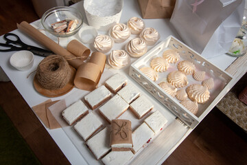 Homemade marshmallows of different shapes and sizes. Spread out on the table. Cooking zephyr at home.