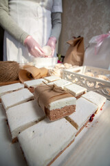 A woman is packing homemade marshmallows. Cooking marshmallows at home.