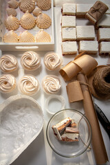 Homemade marshmallows of different shapes and sizes. Spread out on the table. Cooking zephyr at home.
