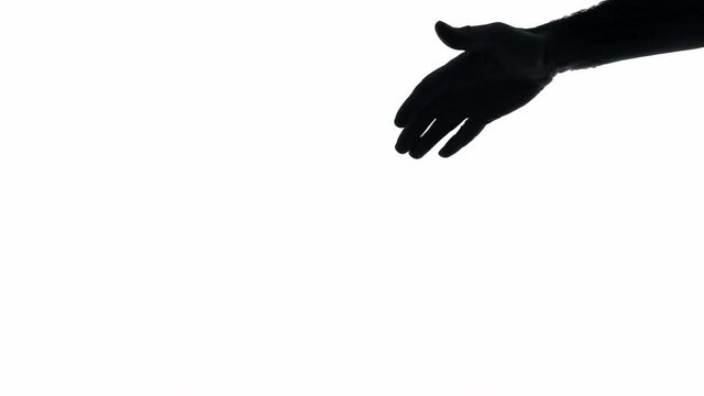 The silhouette of a man's hand giving help, appearing from the top right of the screen, going down to the bottom left.
