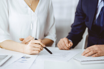 Unknown businessman and woman discussing contract in office. closeup.Business people or lawyers working together at meeting. Teamwork and partnership