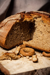 Bread and drying lie on a wooden board on a dark background