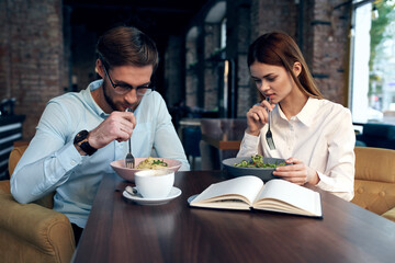 young couple in a cafe at the breakfast table communication lifestyle