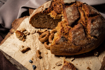Bread and drying lie on a wooden board on a dark background