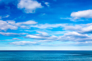 Fototapeta na wymiar View to the sea and blue cloudy sky