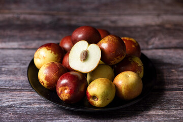 fresh sliced chinese jujubes on wood background