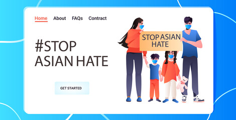 stop asian hate family in masks holding banner against racism support people during coronavirus pandemic