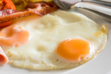 Double fried egg and bacon on dish for breakfast time