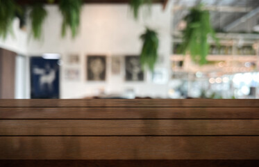 Empty wooden table top with lights bokeh on blur restaurant background