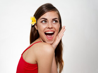 surprised woman with open mouth and yellow flower in her hair red t-shirt model