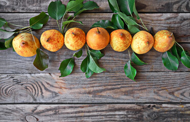 Naklejka na ściany i meble Fresh yellow pears on wooden background. Copy space. Top view.