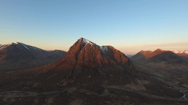 4k time lapse of sunrise in Glencoe. Taken from summit of Beinn a'Chrulaiste mountain looking towards the iconic Buachaille Etive Mor, which the sun gradually lights up. Snow on summit.