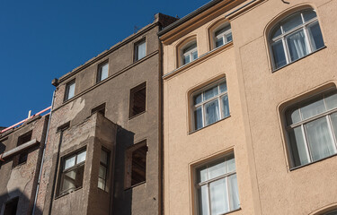 Fototapeta na wymiar Old vs New, renovated old building and building in need of renovation in berlin