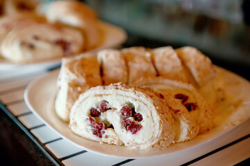 sweet roll with white filling with raspberries in blur