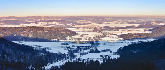 The village of Wambierzyce located in a mountain valley, winter panorama from a viewpoint.