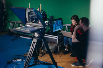 Director at work on the set.  Shooting shift, equipment and group. Modern photography technique.