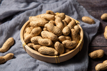 Raw fresh peanuts on wood background