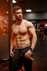 Fototapeta na wymiar Handsome power bodybuilder with shirtless torso. Muscular male posing for camera.