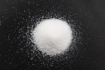 Close up of salt on black background.