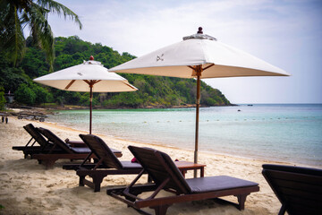Beach chair under coconut tree looking away to sea view. Praw Bay, Samed,Thailand.
