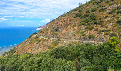 Fototapeta na wymiar Aerial view of the famous D80 road around Cap Corse peninsula, the important tourist path in Corsica Island. Haute-Corse, France. Tourism and vacations concept