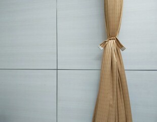 The brown curtains are tied behind the white walls, giving the interior an idea.