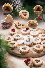 Classic holiday linzer cookies with red jellycookies with jam hearts flying in the air 