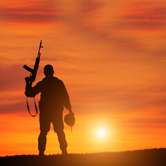 Silhouette Of A Solider Saluting Against the Sunrise. Concept - protection, patriotism, honor.