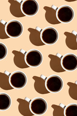 A top view on a coffee cup on beige surface, a hard light pattern