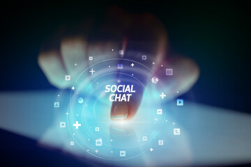 Finger touching tablet with social media icons concept