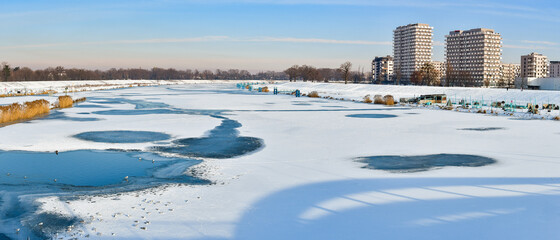 Ice floe in winter across the width of the Odra River in Wroclaw. The ice-bound river makes it impossible to navigate.