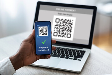 Black man scanning barcode from laptop using smartphone