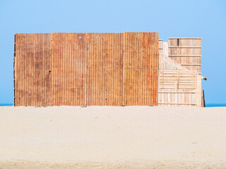 Fototapeta premium Wooden construction on the beach in Constanta Romania. Summer beach vacation landscape