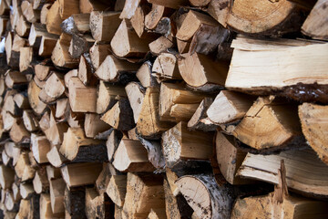 Stacks of firewood background, close-up