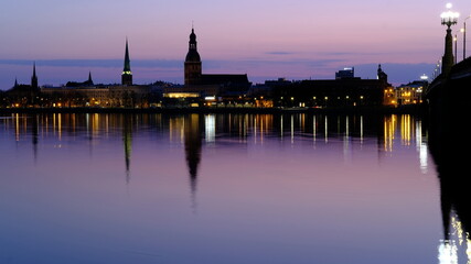 Fototapeta premium Spring sunrise over old Riga reflected in the mirror of the Daugava