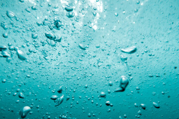 Underwater View of Bubbles In Deep Blue Sea. Close Up Water. Background